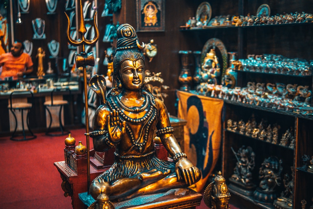 gold buddha figurine on brown wooden table