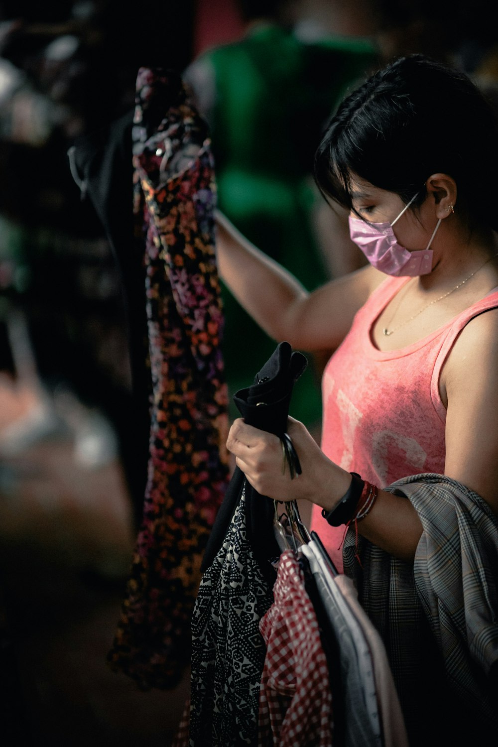 woman in pink tank top wearing white headphones