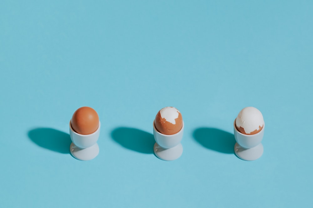 white and brown egg on green surface