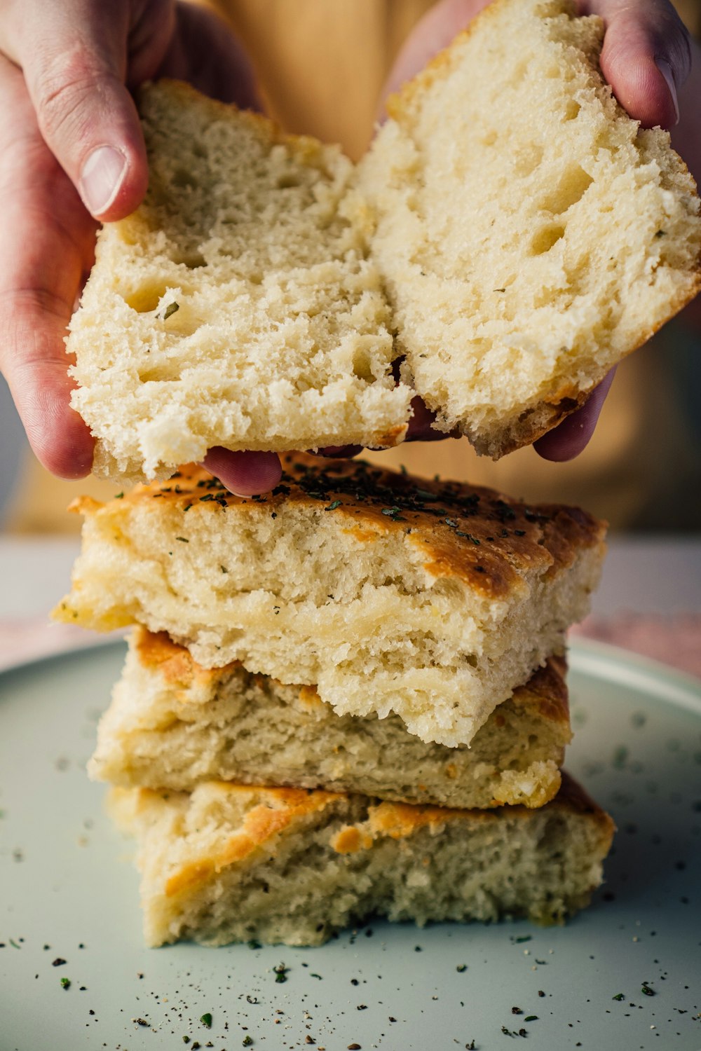 person holding bread with cheese