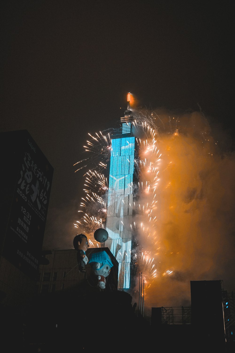 man in green shirt standing near building during night time