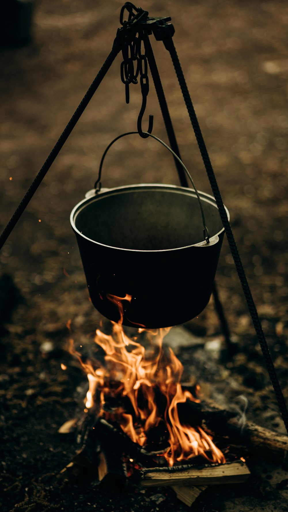 a pot sitting on top of a fire next to a stove