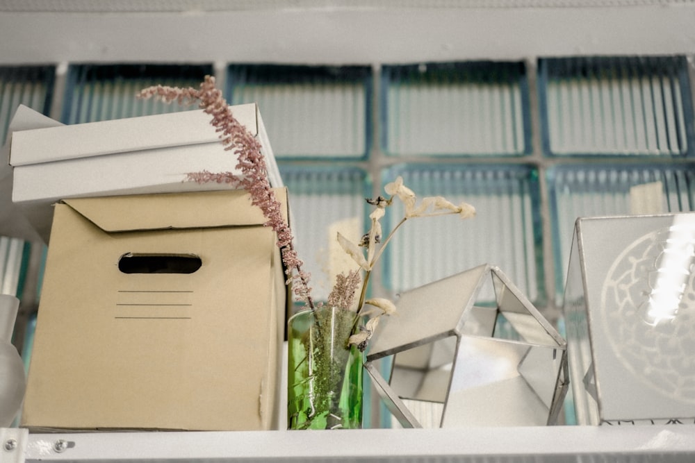 white cardboard box on white wooden shelf