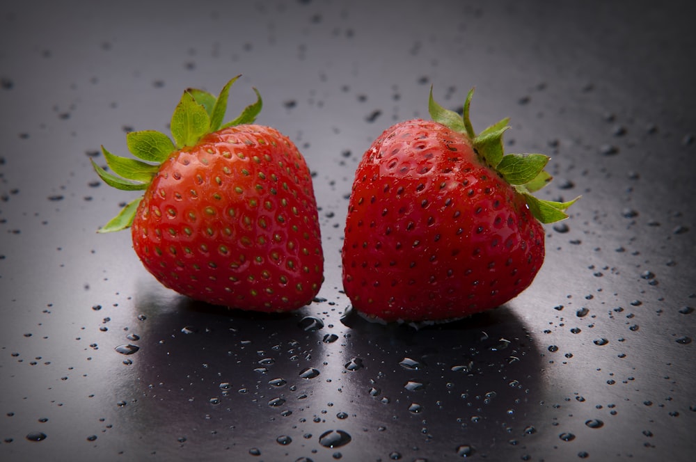 red strawberry on white surface