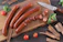 Elegant close-up of premium cured sausages arranged on rustic wooden board.