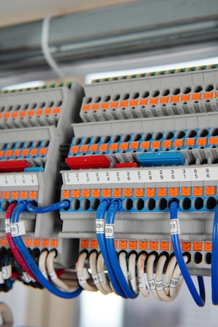 Close-up of detailed cable block diagrams and wiring schedules on a desk.