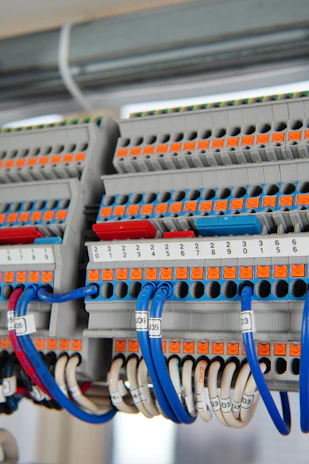 Wide-angle view of a completed electrical installation in a manufacturing plant, highlighting clean and organized wiring.