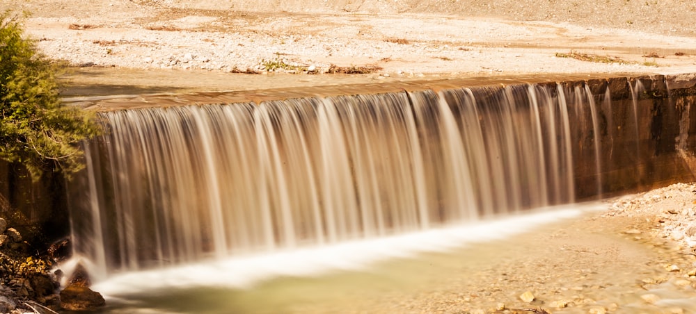 water falls on brown sand