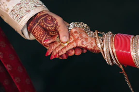 person wearing gold bracelet and gold bracelet