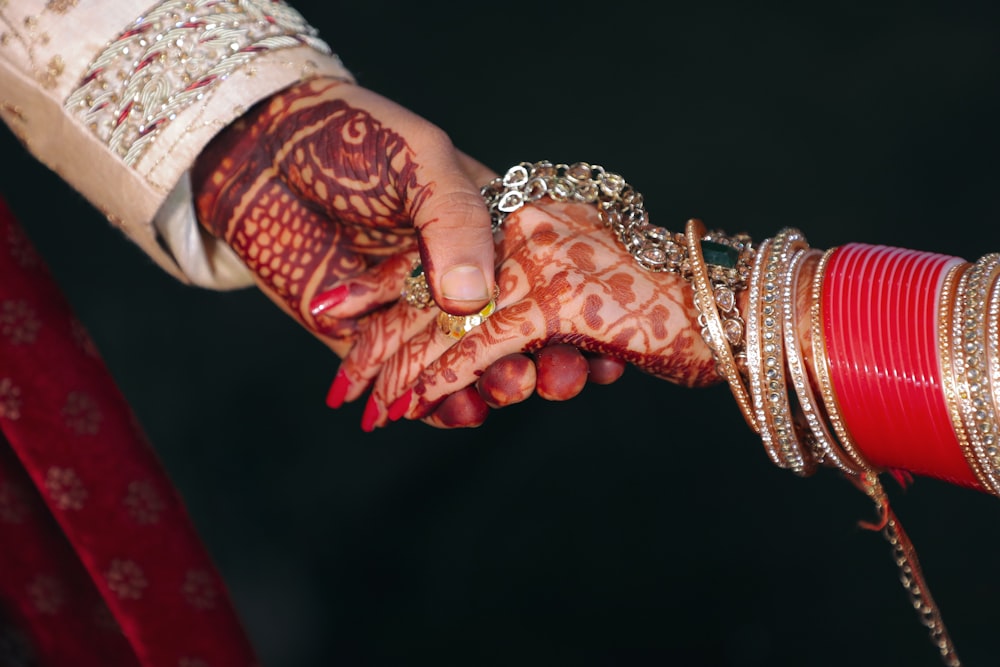 person wearing gold bracelet and gold bracelet