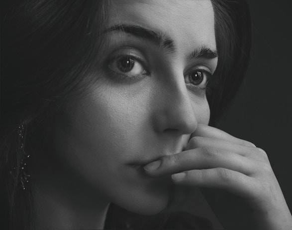 An artistic black-and-white portrait of a confident woman looking away.