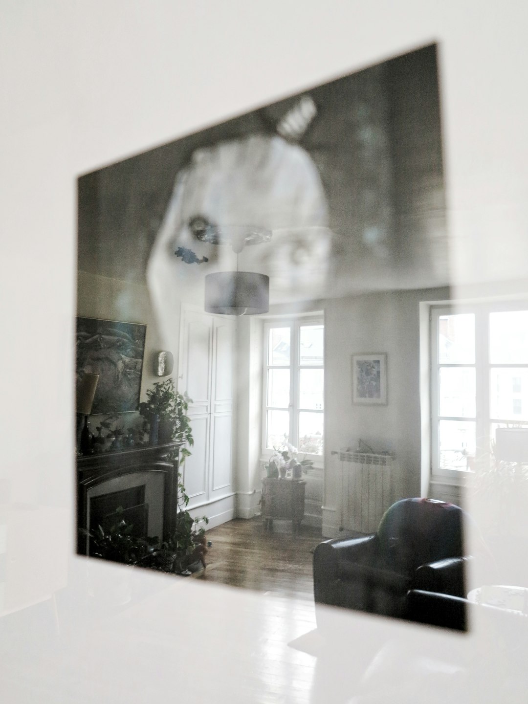 black leather armchair beside white wall