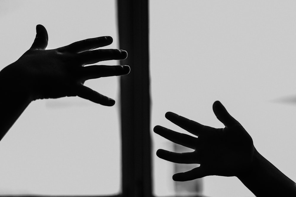 persons hand with black manicure