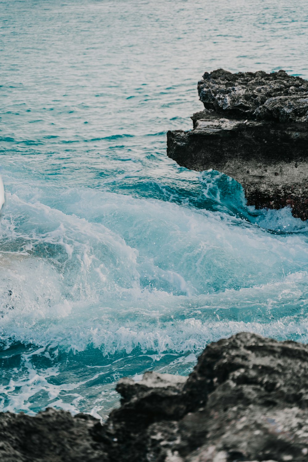 ocean waves crashing on rocks during daytime