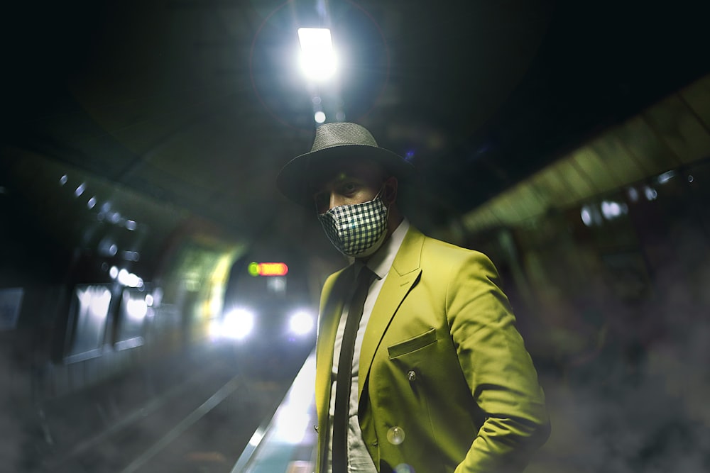 man in yellow suit jacket wearing black cap