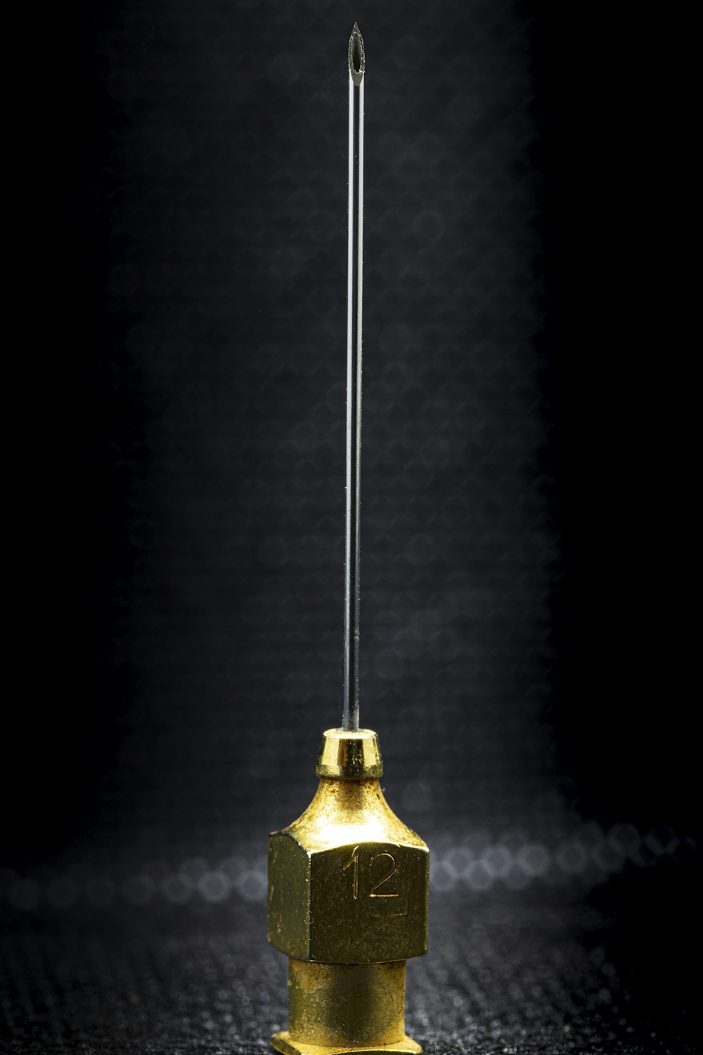 gold bell on black surface