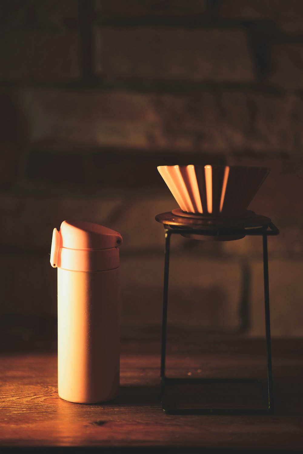 stainless steel candle holder beside brown pillar candle