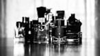 grayscale photo of perfume bottles