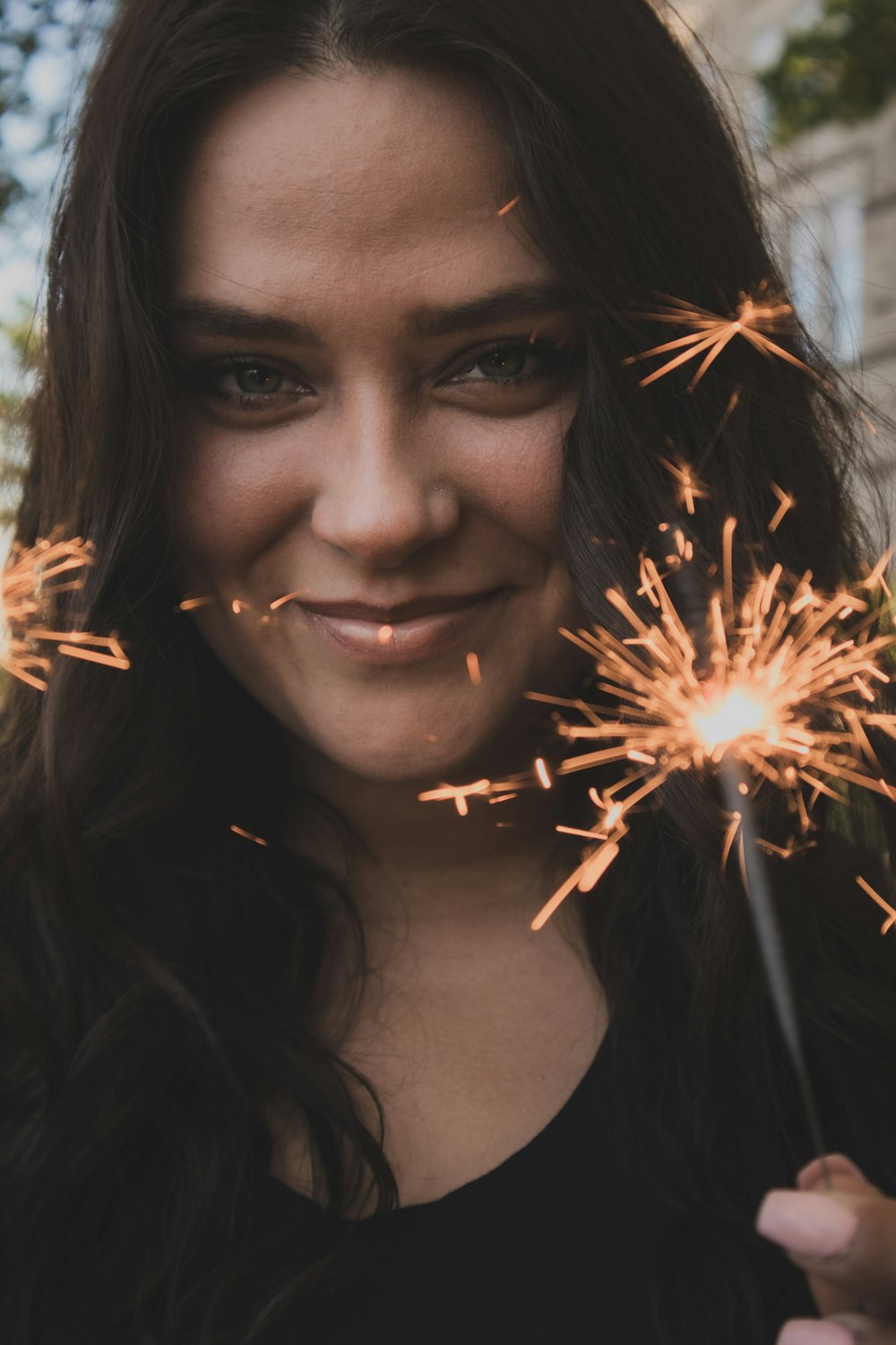 woman holding sparkler during daytime