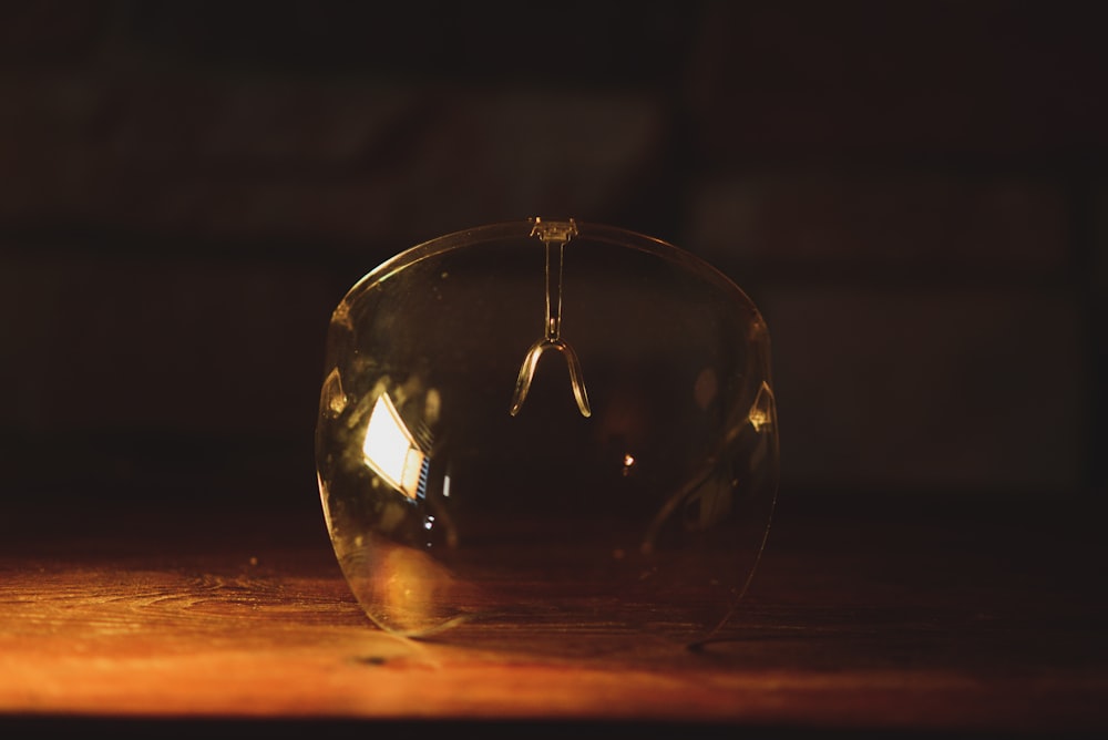 clear glass ball on brown wooden table