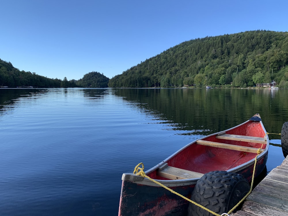 red boat on lake during daytime