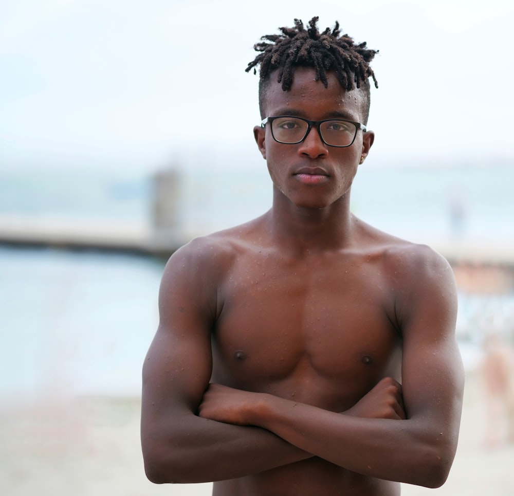 topless man wearing black framed eyeglasses