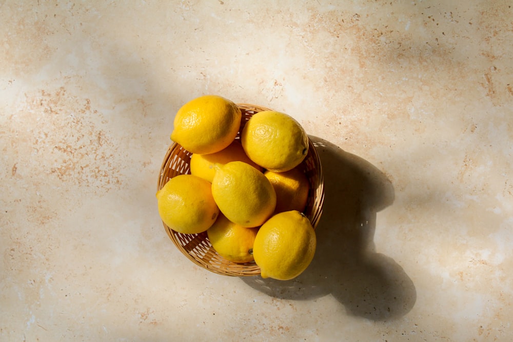 yellow lemon fruits on brown woven basket