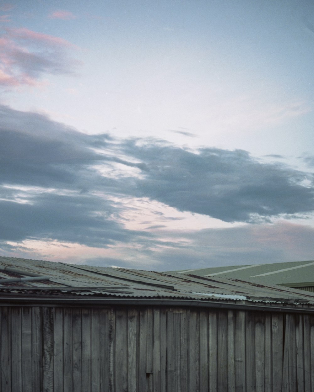 brown wooden fence under cloudy sky during daytime