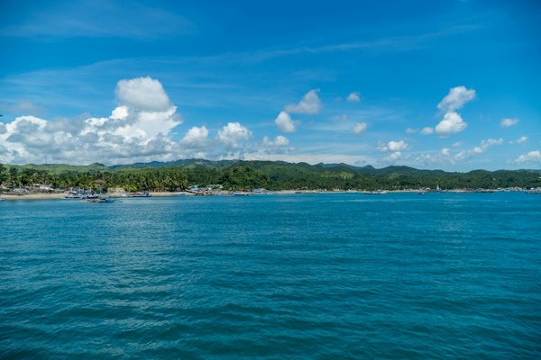 Blue sea under blue sky and white clouds during daytime — Boracay, Philippines