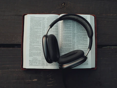 black wireless headphones on white book page