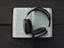 black wireless headphones on white book page