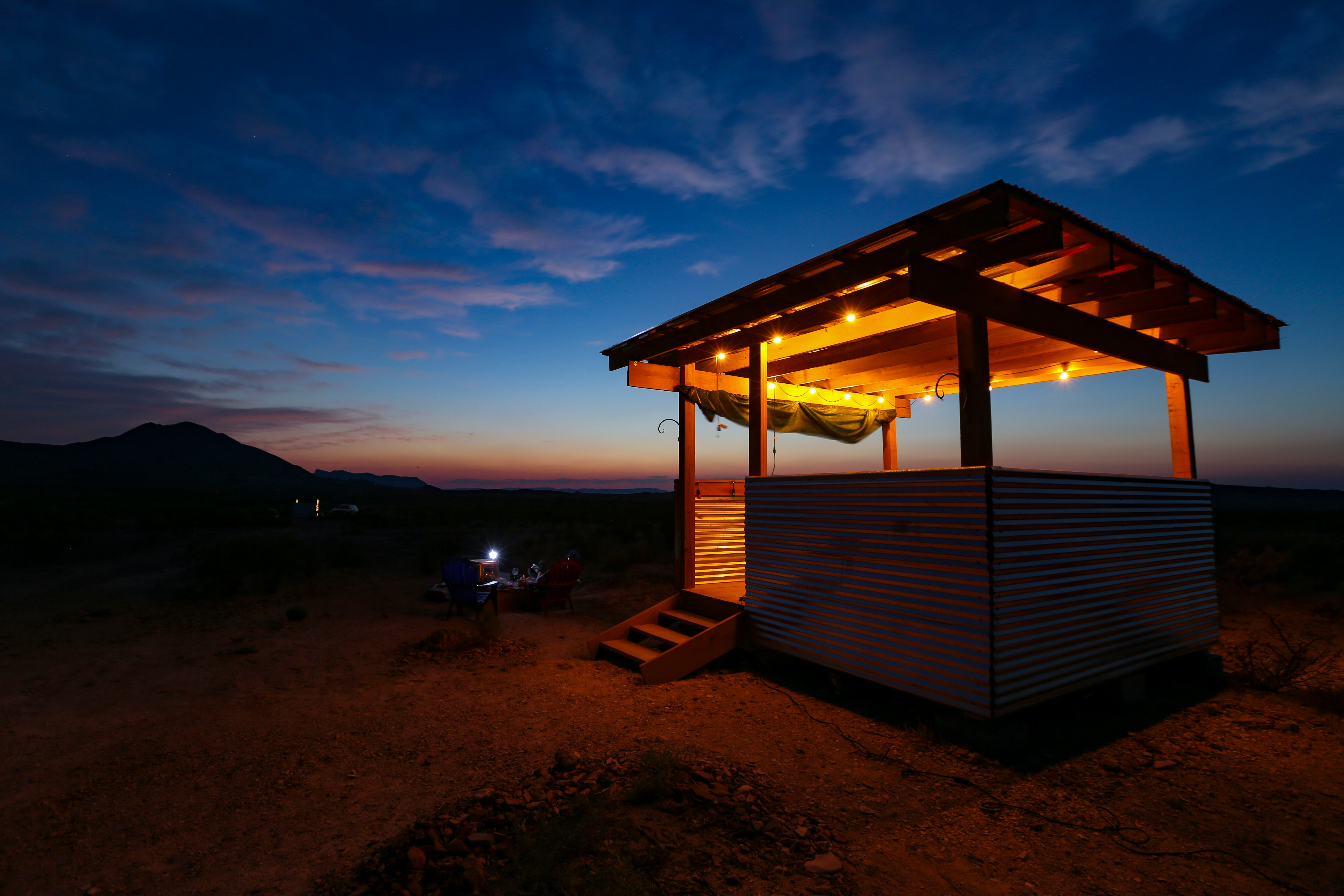 brown wooden gazebo on beach during sunset