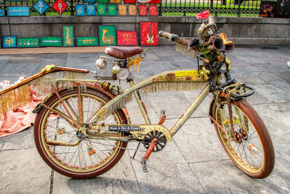 yellow city bike parked beside red metal fence