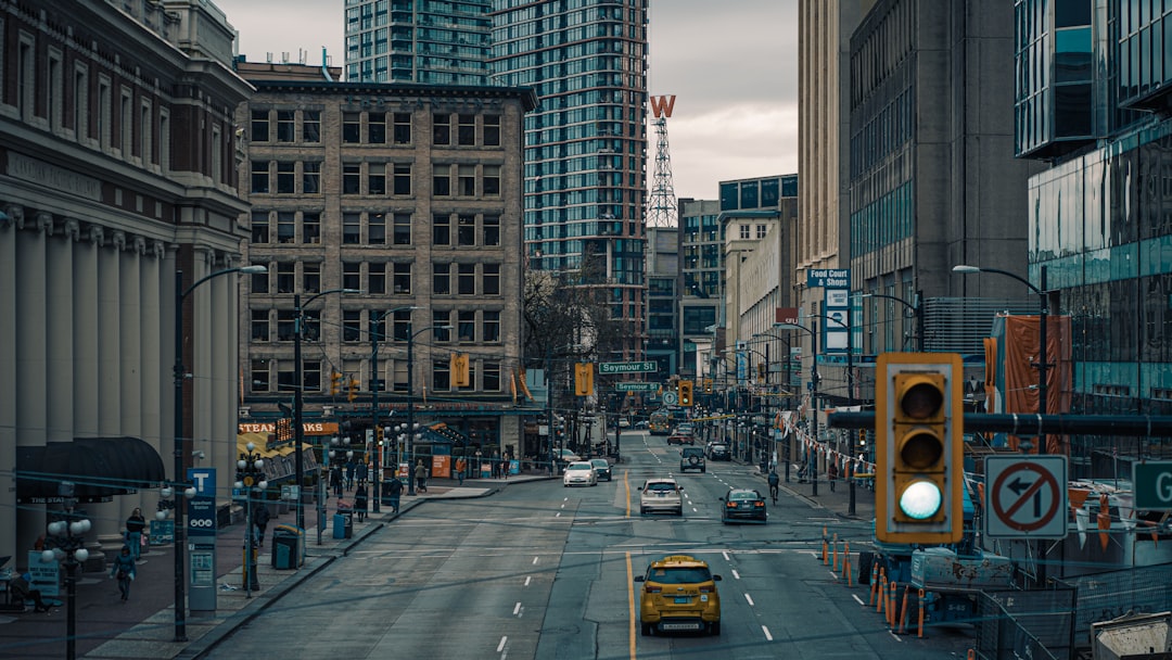 cars on road near high rise buildings during daytime