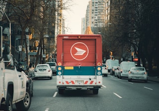 red and white bus on road during daytime