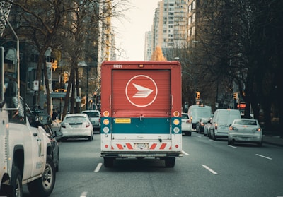 red and white bus on road during daytime