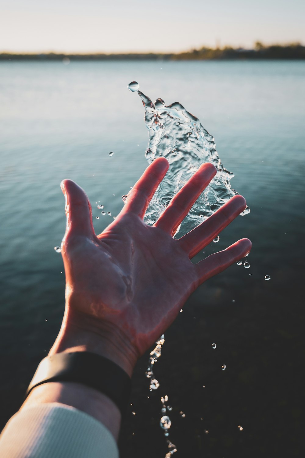 persons left hand with water droplets