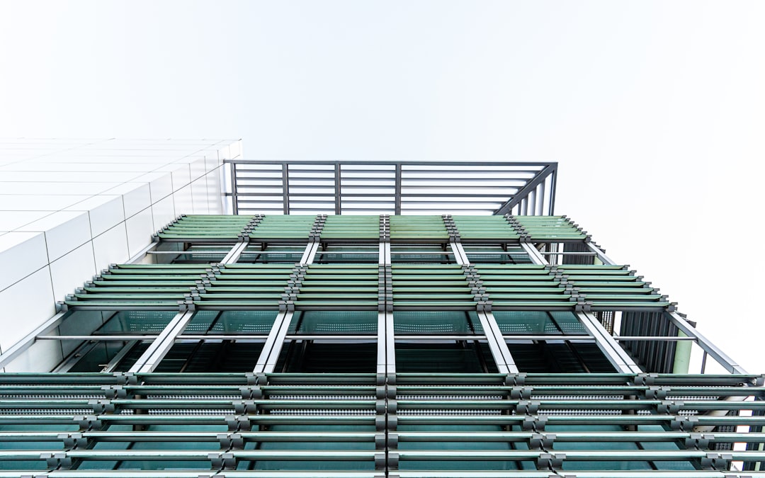 low angle photography of high rise building, Metal Louvered shading device (brisoleil) on the Ministry of Education Buil