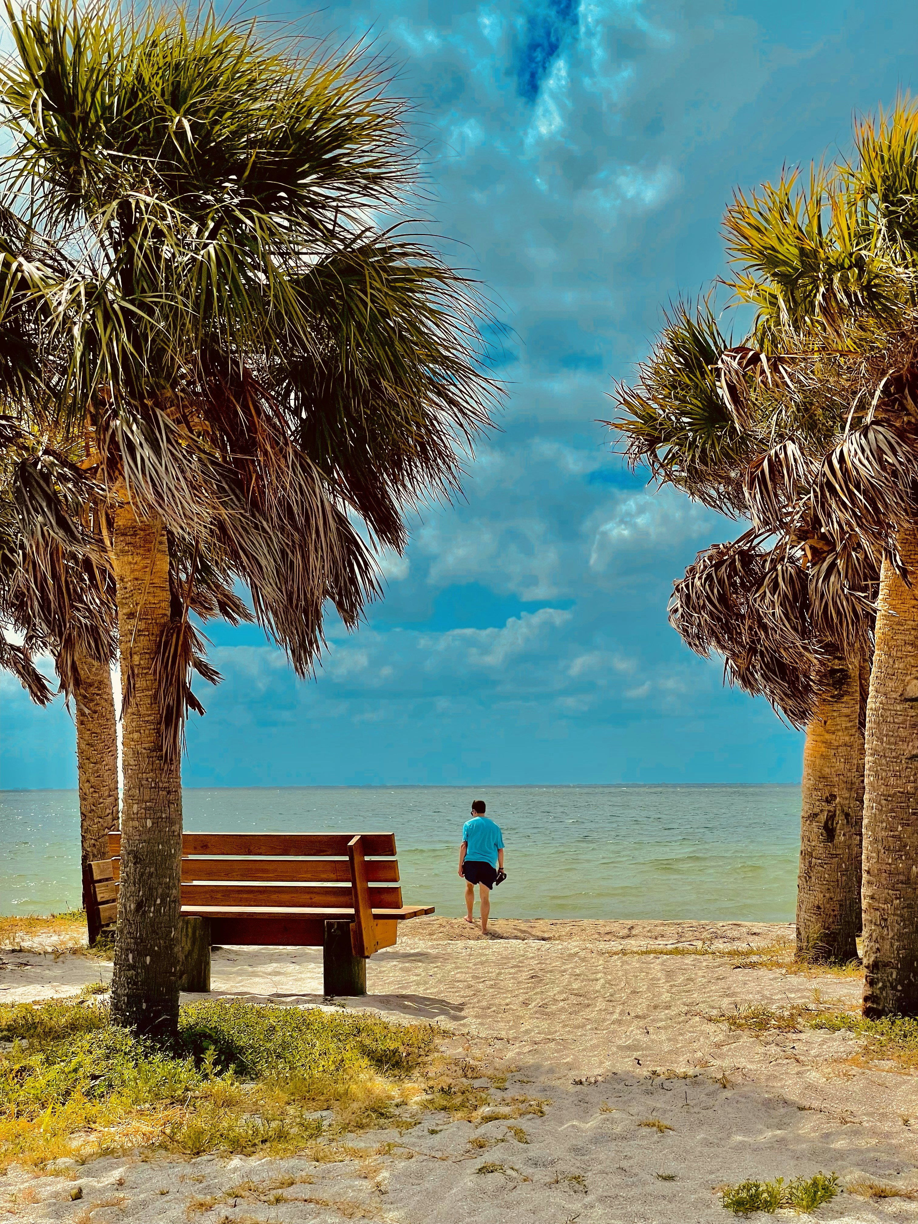 woman in blue dress standing on beach during daytime