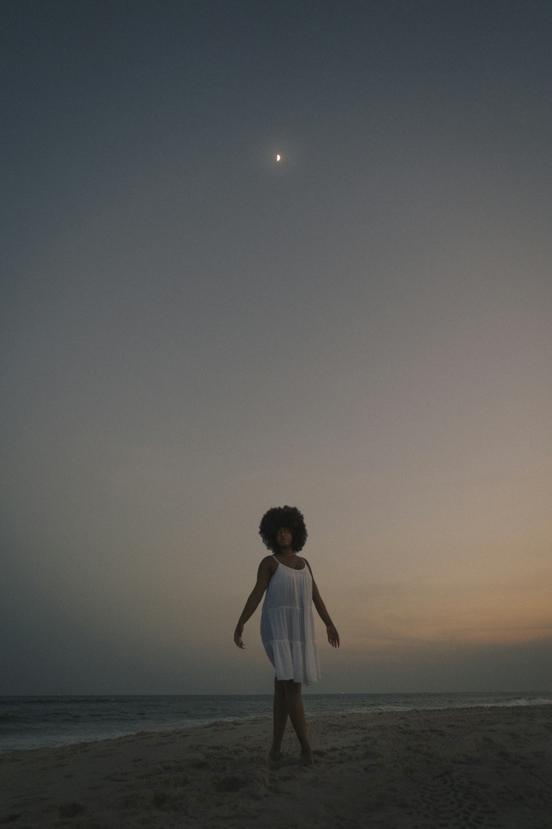 woman in white dress standing under blue sky during daytime