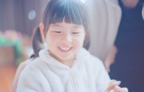 smiling girl in white hoodie