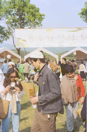A vibrant outdoor cannabis expo with booths, sponsors, and happy visitors under sunny skies.