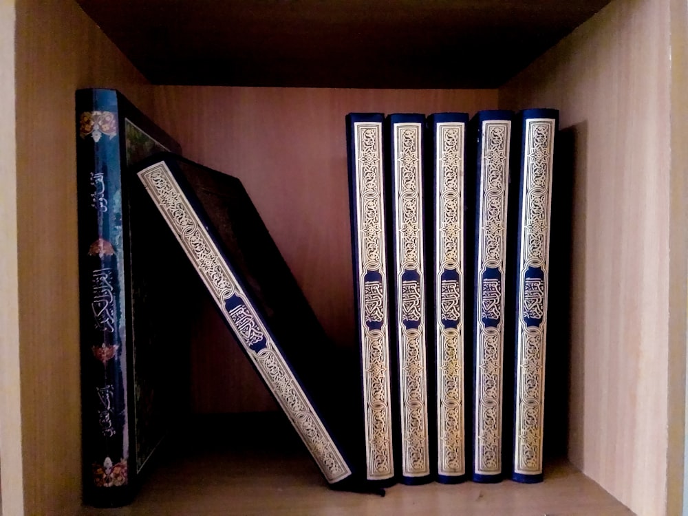 white and black books on brown wooden shelf