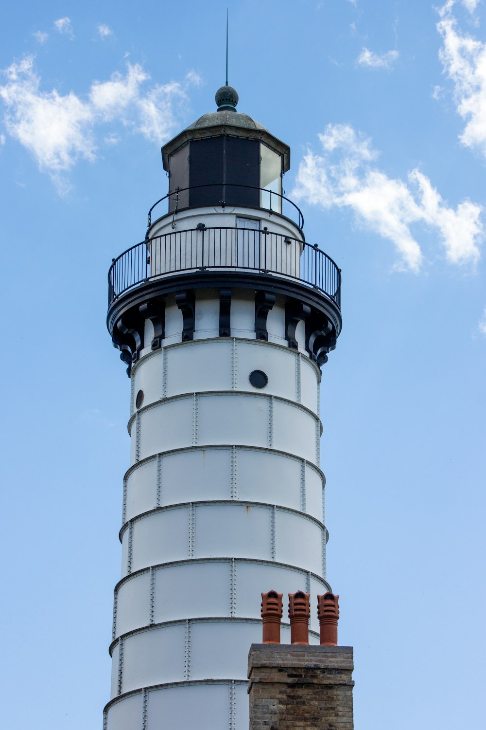 white and black concrete tower under blue sky during daytime