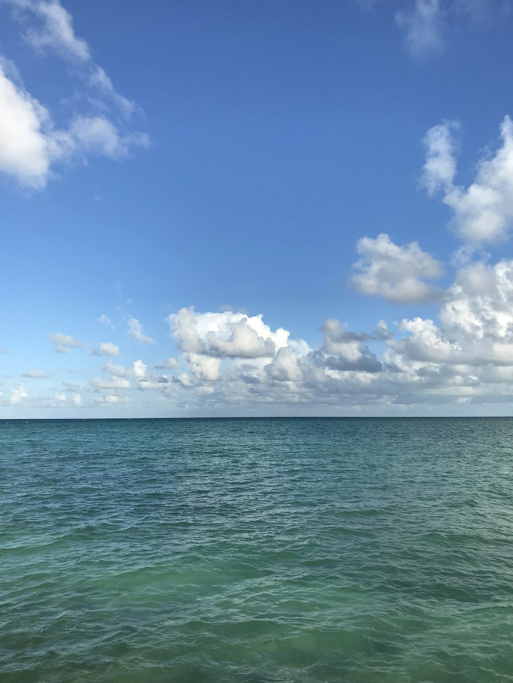 blue sky and white clouds over sea