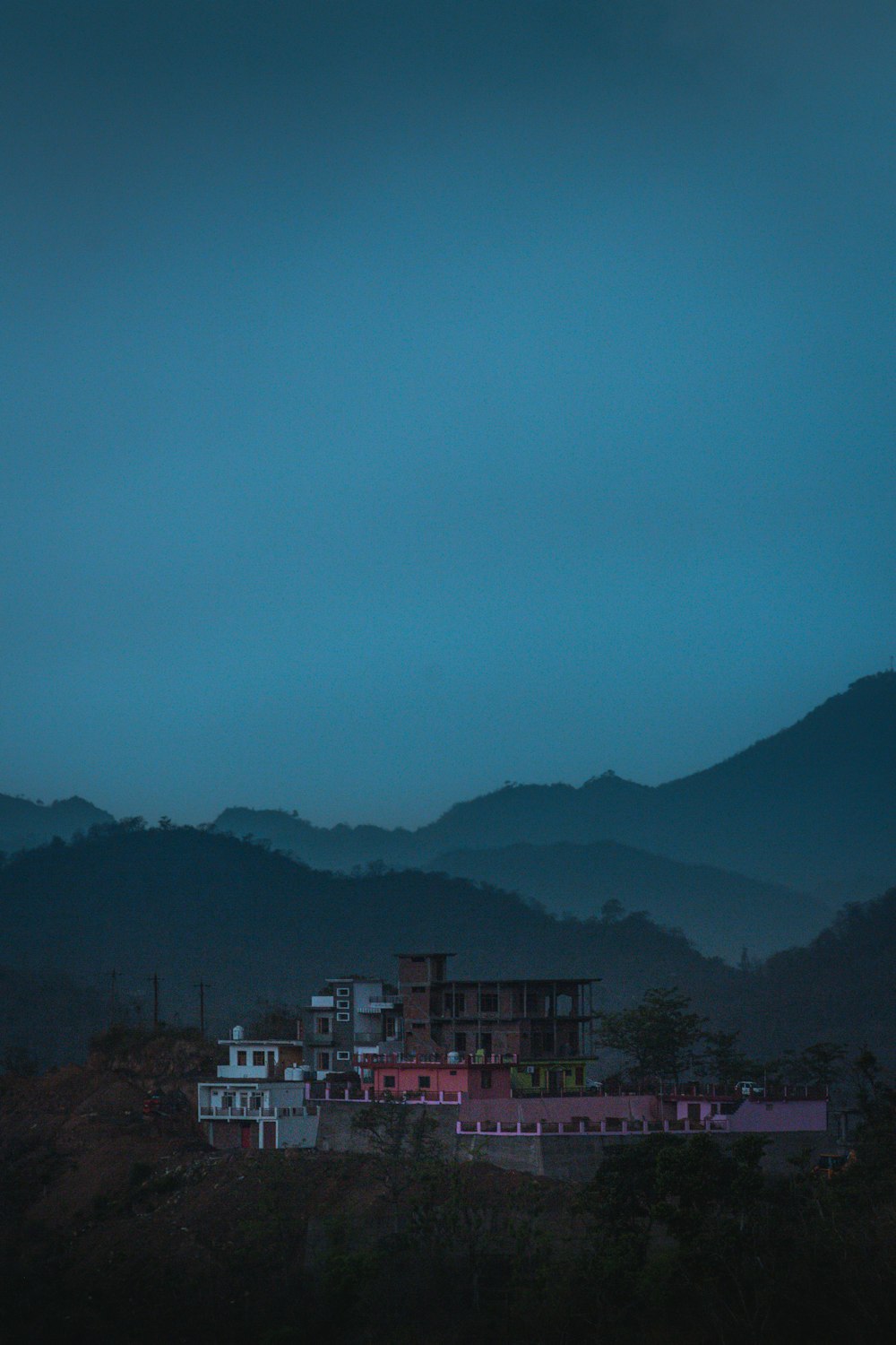 red and white building near mountain during daytime