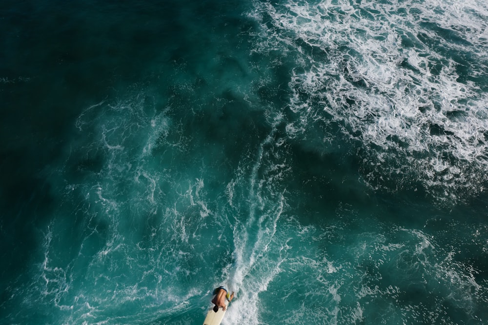 person surfing on sea waves during daytime