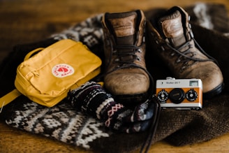 brown leather boots beside yellow plastic bag