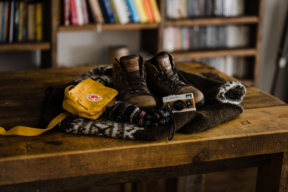 black and brown leather boots on brown wooden shelf