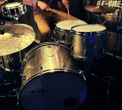 man in black shirt playing drum